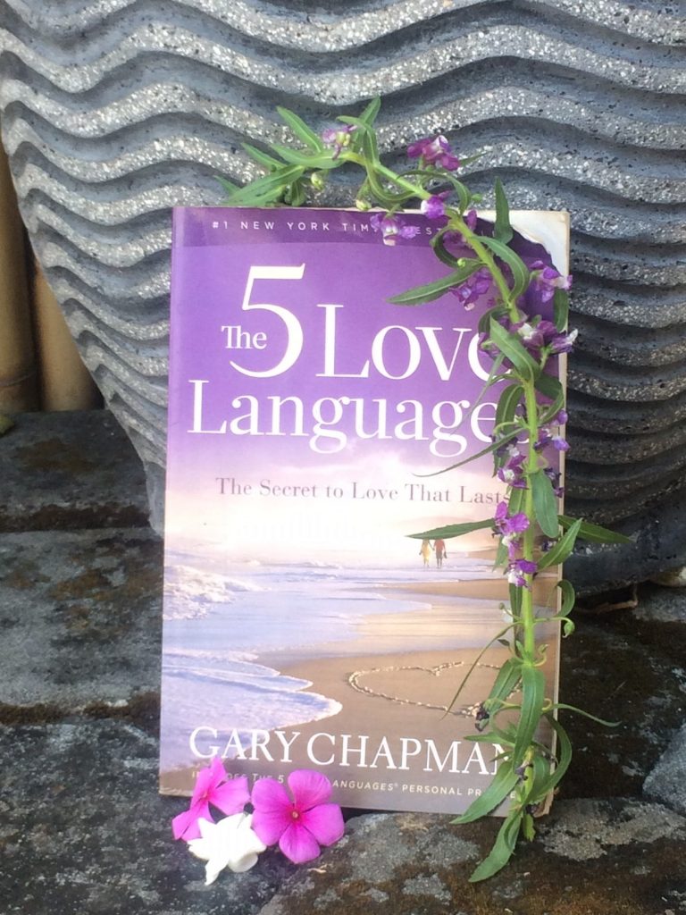 the 5 love languages book propped up on a pot